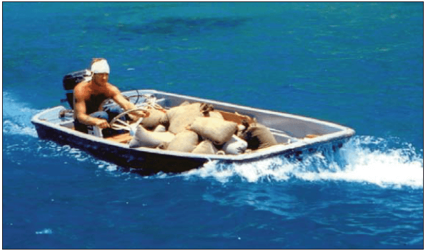 Point Banks crewman “Frenchy” Benoit ferrying supplies in the ship’s 13-foot Boston Whaler 